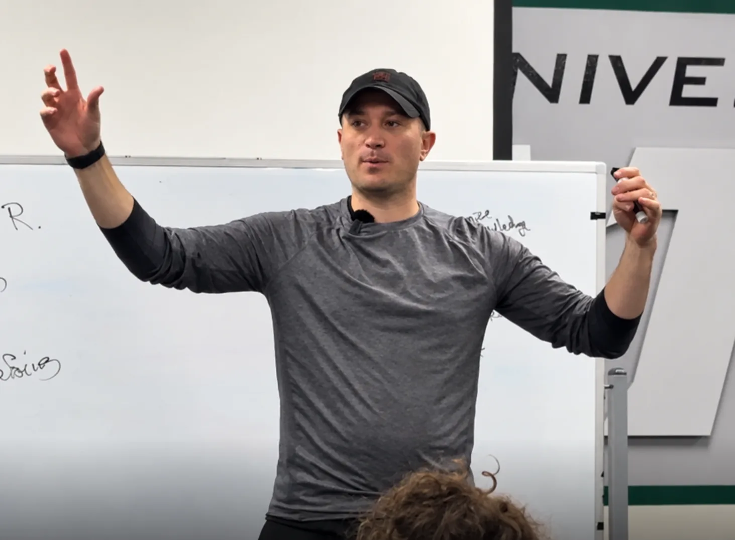 Trevor Conner leading a workshop beside a whiteboard
