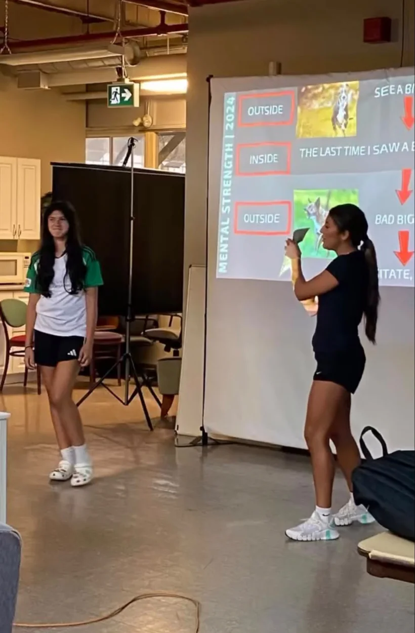 Jessica demonstrating a mental performance exercise with an athlete